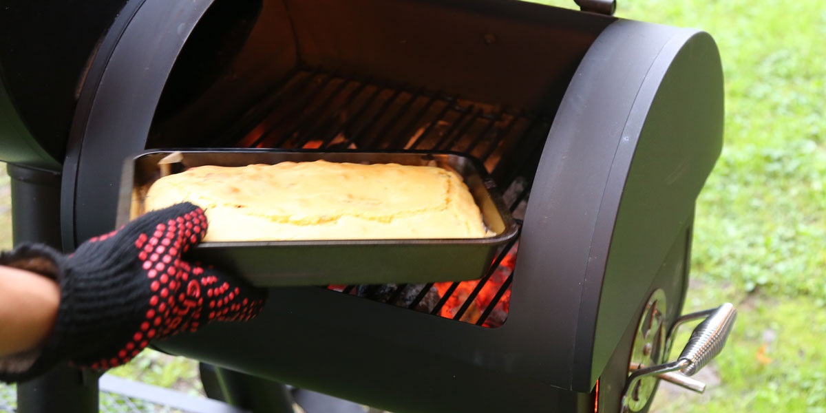 The smoker cornbread is ready when the bread pulls away from the edges of the dish