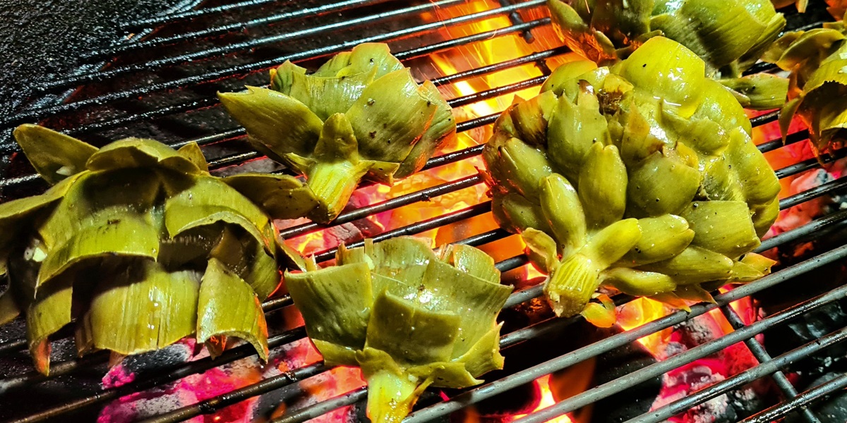 After pre-cooking and brushing with marinade, grill the Artichoke halves over a hot grill.