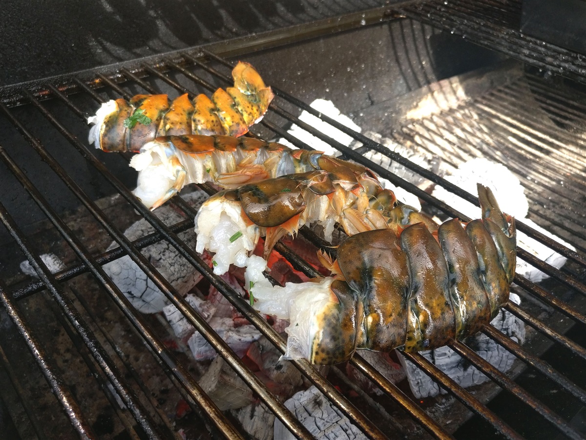 Cut tails in half and put on direct heat for 2 mins. Make sure you raise charcoal grate so crayfish aren't too close to heat source.