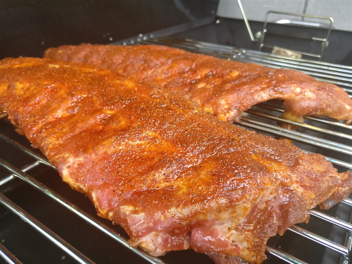 Place ribs on preheated Cob, over the roasting dish with apple juice and hot water in it.
