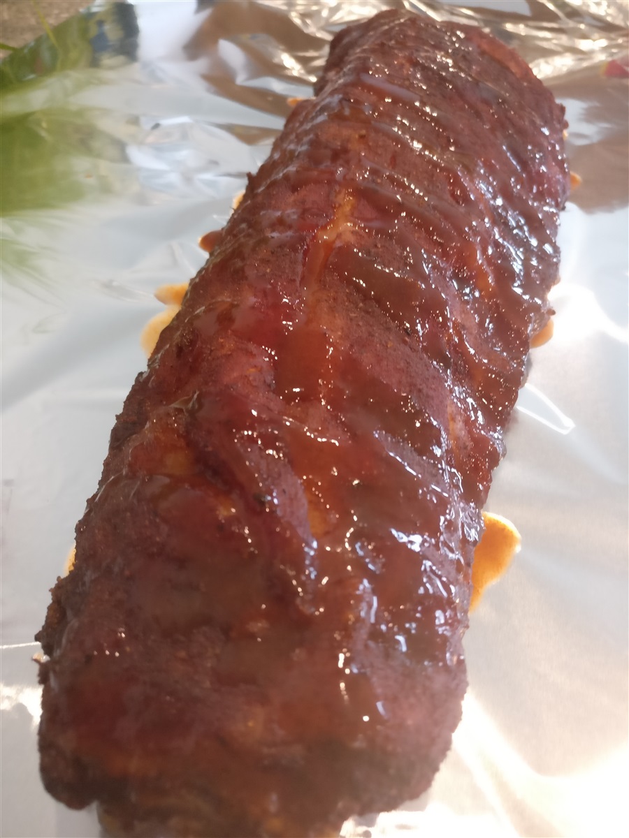 After 2 hours, remove ribs and apply BBQ sauce. Wrap in foil.