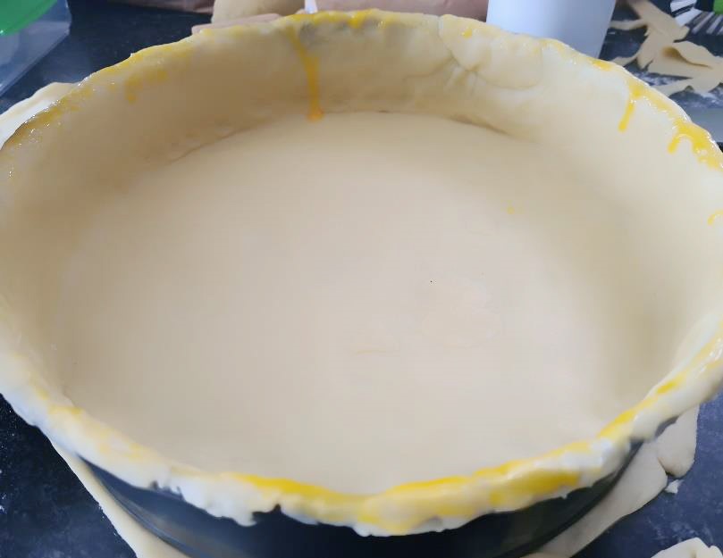 Line pie dish with pastry.