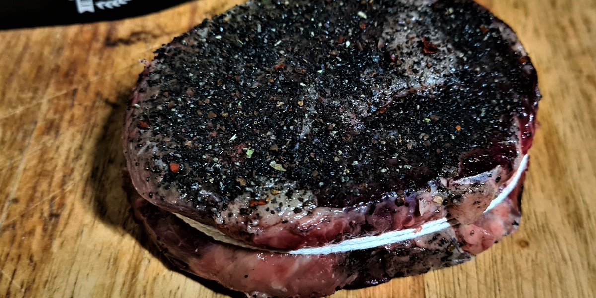 Tie the Ribeye with Butchers Twine and cover in your favourite rub.