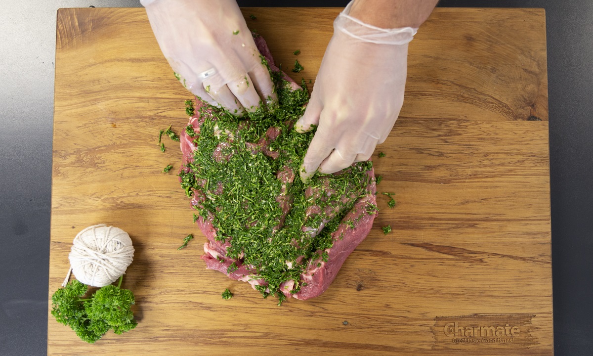 Blitz herbs in blender until coarse, then spread evenly on one side of lamb.
