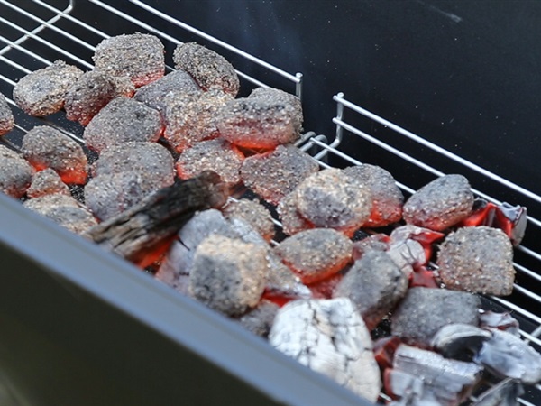 The coals need to be in an even layer to achieve an even cook.